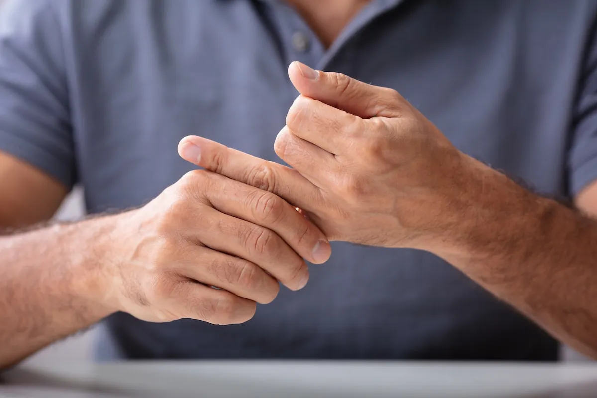 Senior doing gentle range-of-motion exercise for arthritis relief at home - supporting image