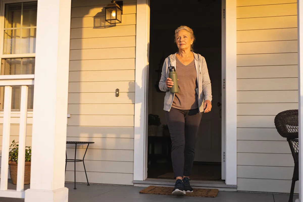 Senior drinking a glass of water at home as part of a daily hydration habit - summary image